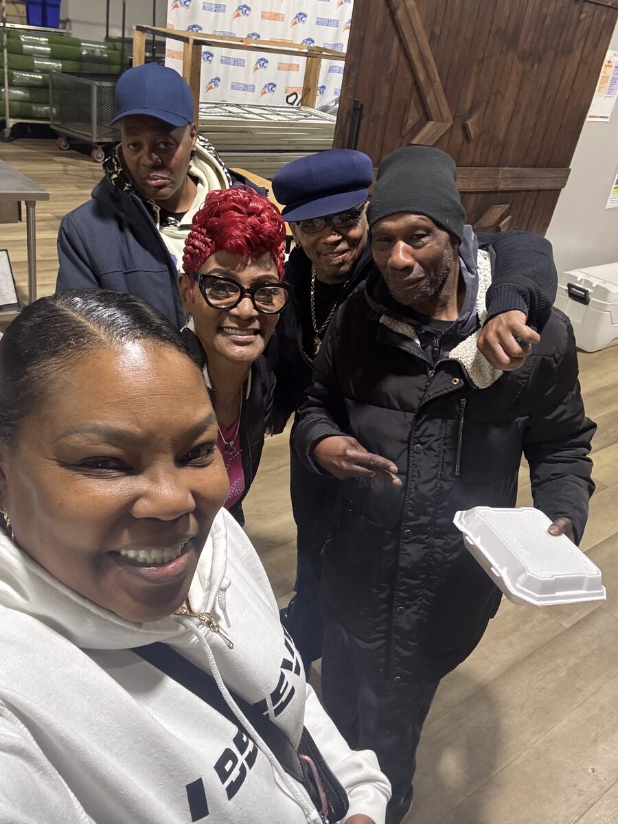 Neighbors gathered together at a Project H.O.O.D. community gathering