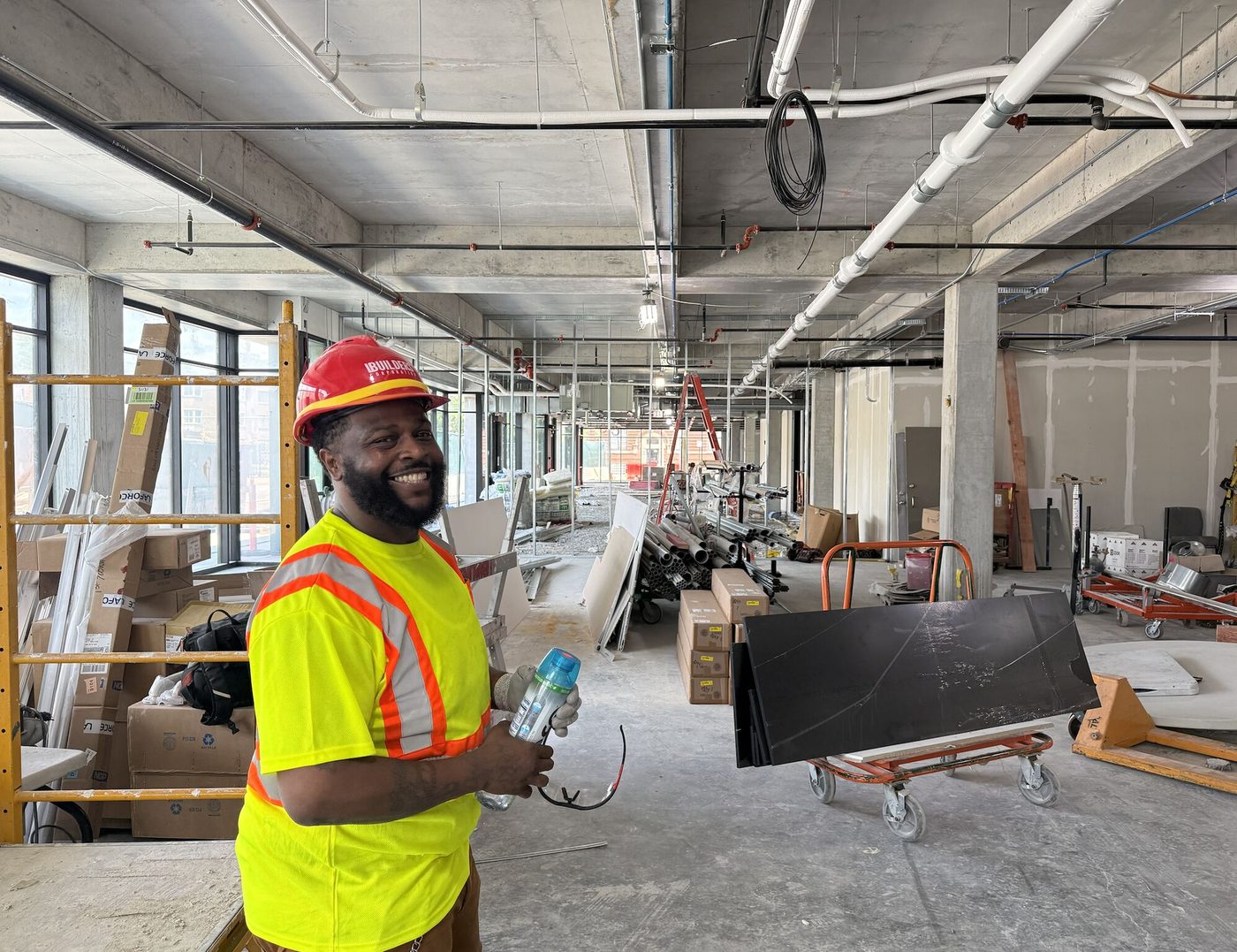 Brandon M. carrying materials inside the LEO Center during construction